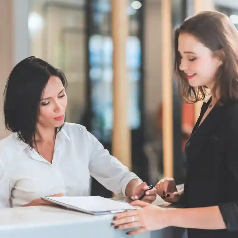 2 Mitarbeiterin arbeiten am Empfang. Unser Service: Empfangsdienst Düsseldorf